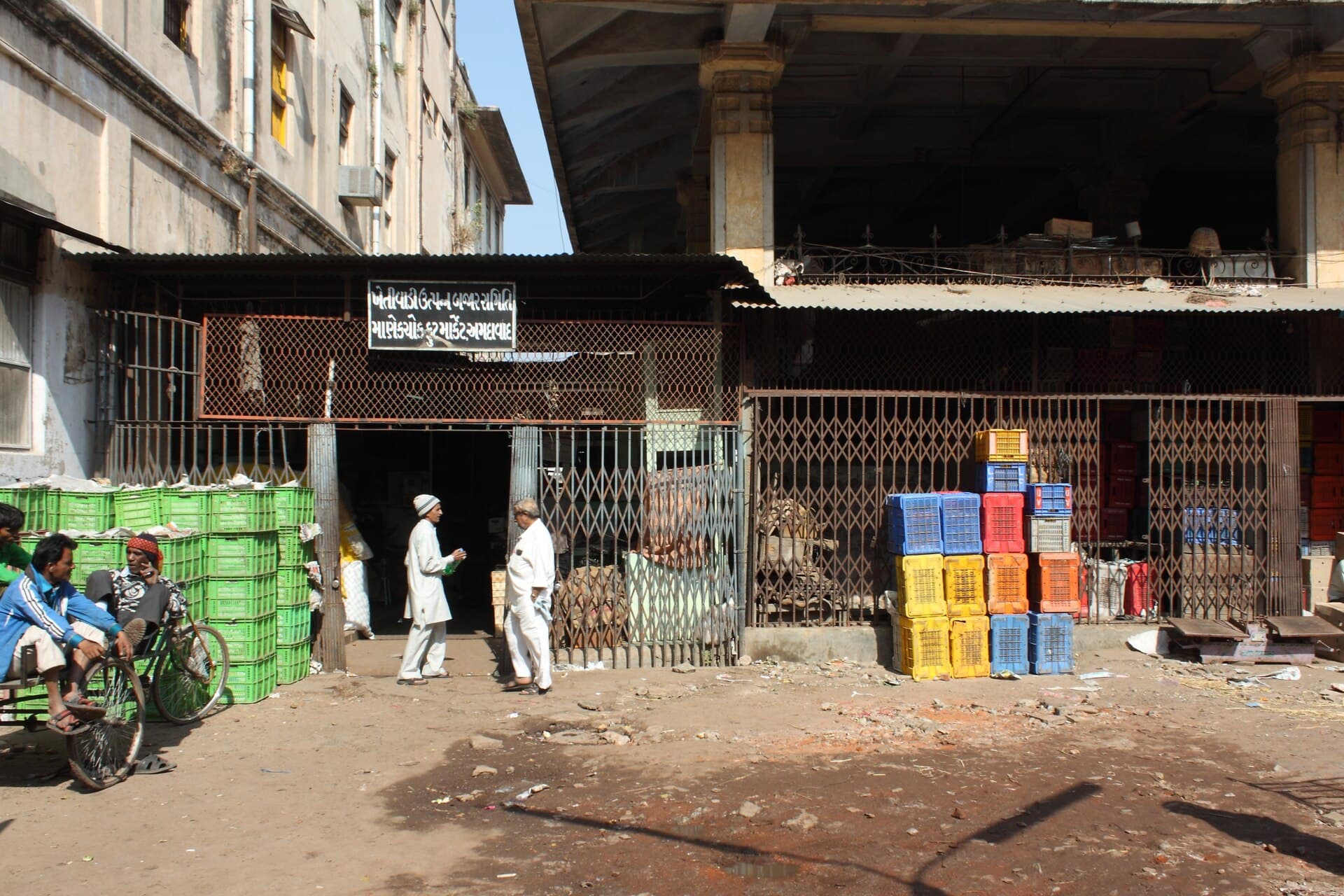 Crates stacked outside the shops at a fruit market in Ahmedabad