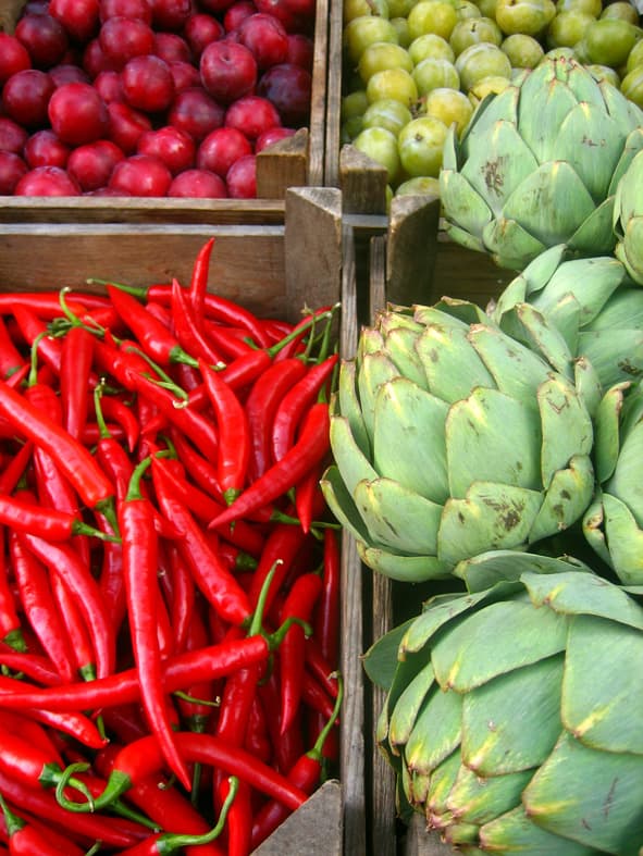 Wooden crates of produce stacked side by side at a market